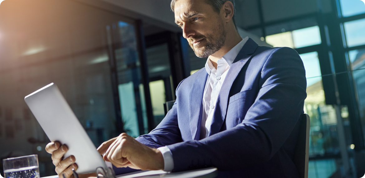 A cryptocurrency director in a suit focused on his laptop, working diligently in an app