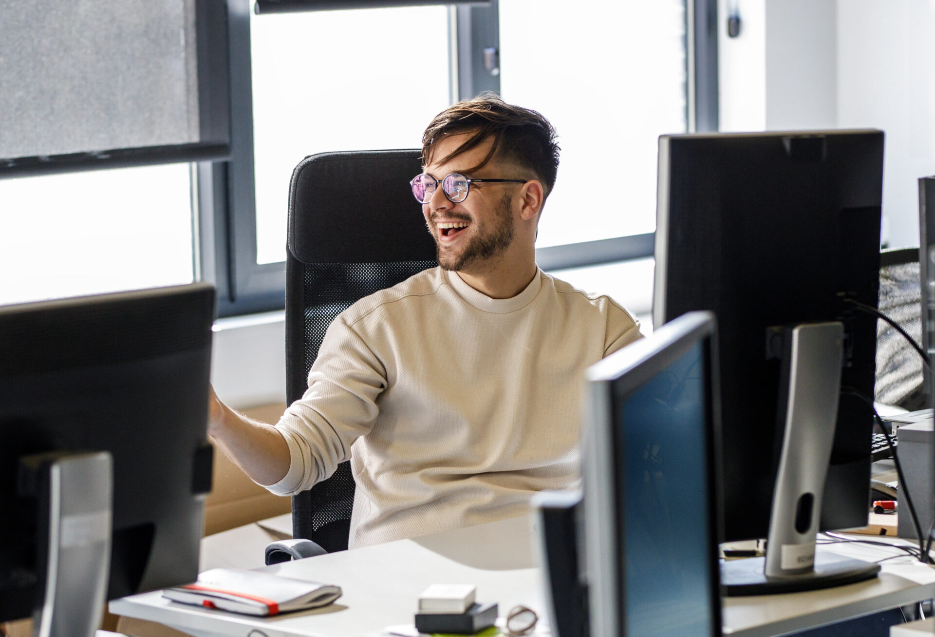 Young white male business development manager smiling at the office